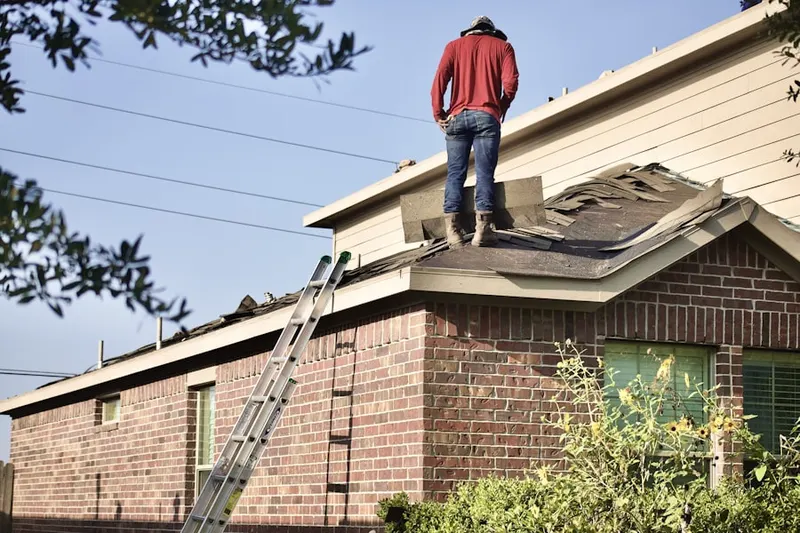 Professional roofer working on a residential roof in Mottville